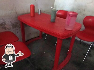 Take a seat at one of the tables at Sardar Ji Sweet & Fast Food