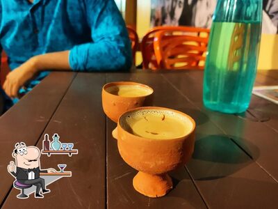 Take a seat at one of the tables at Cafe Tea Zone Katwa