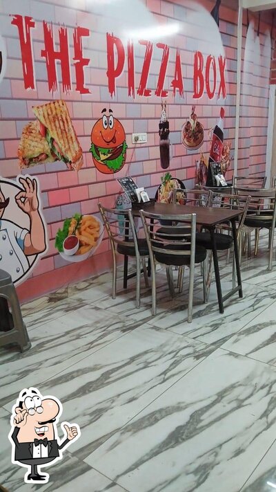 Take a seat at one of the tables at The Pizza Box