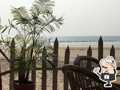 Take a seat at one of the tables at Evisha Beach Shack