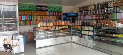 Take a seat at one of the tables at Mariyamman Halwa Bazar - Best Calicut Halwa in Kozhikode