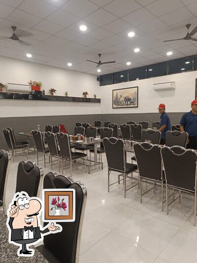 Take a seat at one of the tables at The Rajwadi Restaurant
