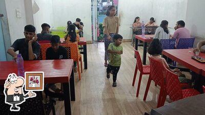 Take a seat at one of the tables at Egr Restaurant Momos Bar