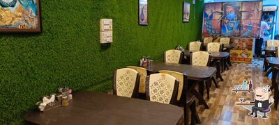 Take a seat at one of the tables at SWAD HOTEL