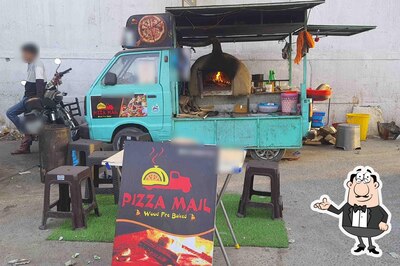 Take a seat at one of the tables at Pizza Mail