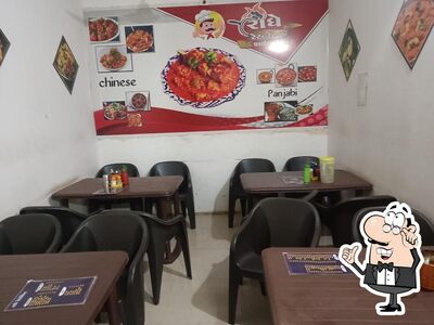 Take a seat at one of the tables at Radhe restaurnt