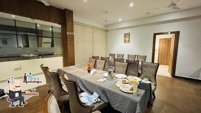 Take a seat at one of the tables at Hotel Samrat & Tourist Home