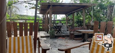 Sente em uma das mesas no Santo Gole pousada/restaurante/petiscaria e mercearia