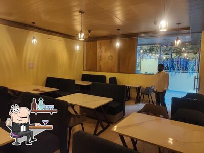 Take a seat at one of the tables at Atithi Restaurant