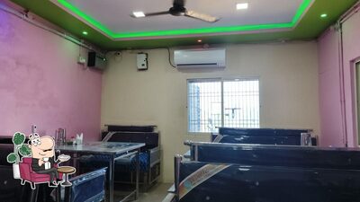 Take a seat at one of the tables at Dharitri Restaurant
