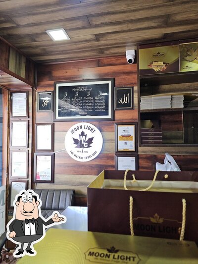 Take a seat at one of the tables at Moon Light - The Walnut Fudge Shop مون لاںٔٹ