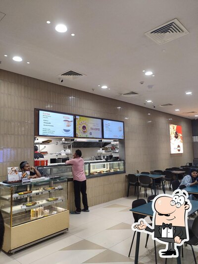 Take a seat at one of the tables at NMR'S UPTOWN EATS- Lulu Mall, Palakkad