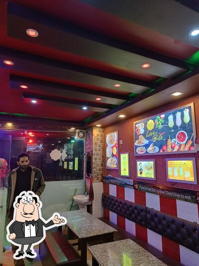 Take a seat at one of the tables at Kathi Junction Sanat Nagar