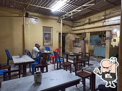 Take a seat at one of the tables at Ponnamma Hotel Dosa Kolar(SSV)