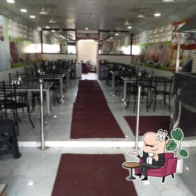 Take a seat at one of the tables at Hotel Surya