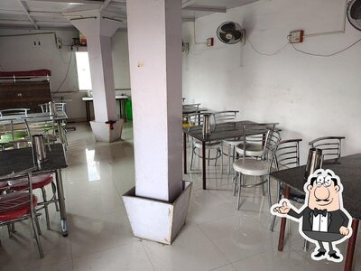 Take a seat at one of the tables at A.C.B RESTAURANT MAMBAKKAM