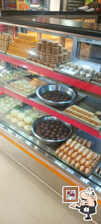 Take a seat at one of the tables at Anand Magan Sweets