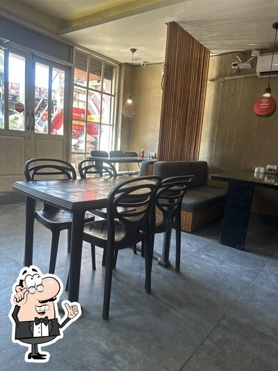 Take a seat at one of the tables at Dpaks Restaurant & Fast Food