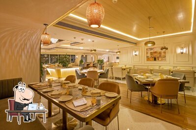 Take a seat at one of the tables at Zaffran- Renaissance Hotel