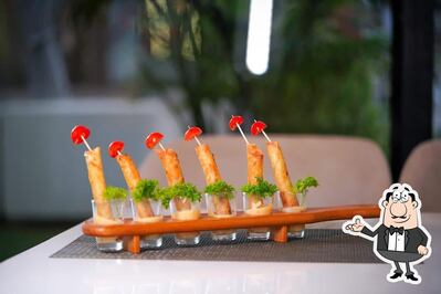 Take a seat at one of the tables at Raada Resto And Cafe