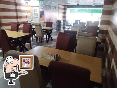 Take a seat at one of the tables at Green apple restaurant and cafe