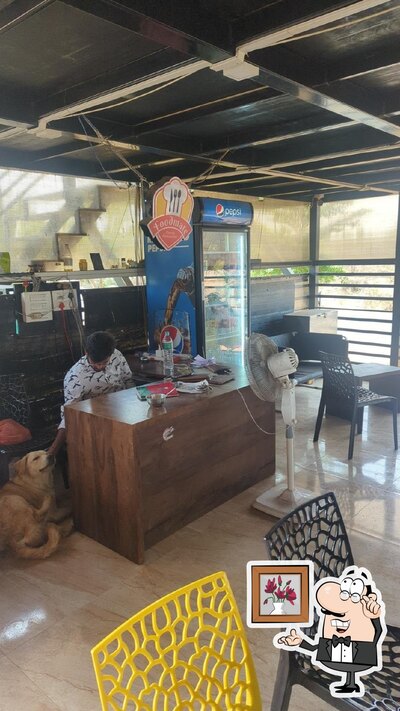 Take a seat at one of the tables at Food Mate Hotel