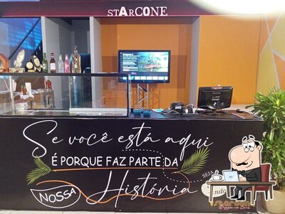 Sente em uma das mesas no Starcone pizza Cone