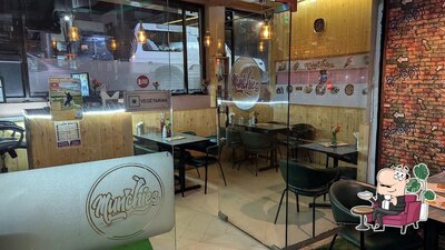 Take a seat at one of the tables at Munchies (pure vegetarian)