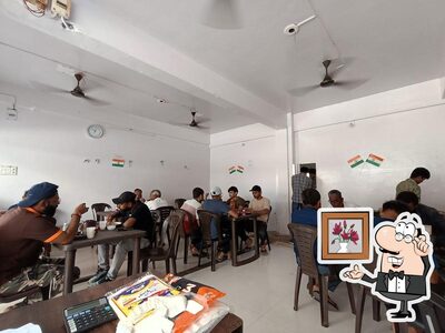 Take a seat at one of the tables at Satvik Dinning Hall
