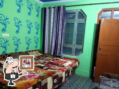 Take a seat at one of the tables at Hotel Badri Kedar