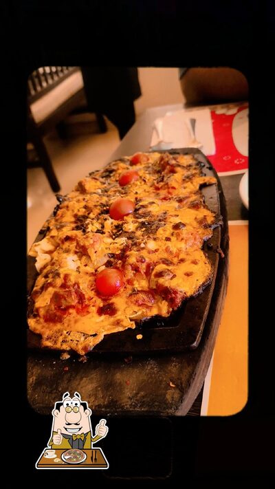At Farmhouse Garden Restaurant / Residency, you can try pizza