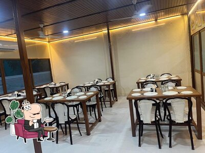 Take a seat at one of the tables at The Grand Ruturaj Restaurant & Caterers