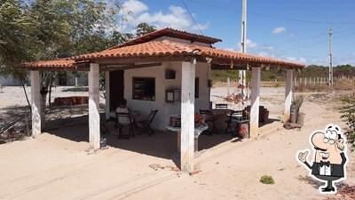 Sente em uma das mesas no QUIOSQUE DA BAIO