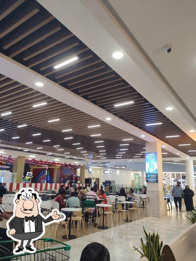Take a seat at one of the tables at NMR'S UPTOWN EATS- Lulu Mall, Palakkad
