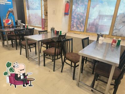 Take a seat at one of the tables at Shakti Sweets (Since 1966)