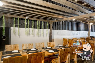 Take a seat at one of the tables at The Gazebo World Of Veg - Veg Restaurant Wakad